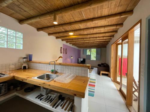 a kitchen with wooden ceilings and a wooden counter top at Casita Azul in Salento