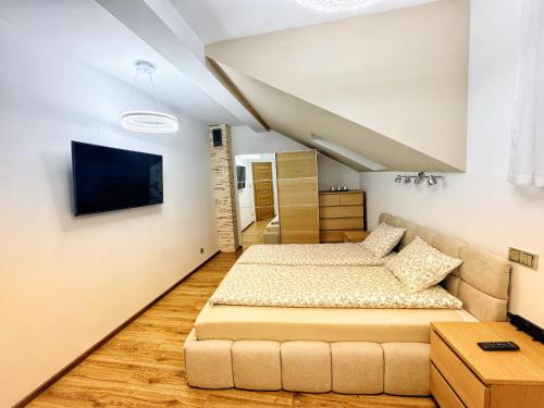 a bedroom with a bed and a couch at Apartament Premium Skawina in Skawina