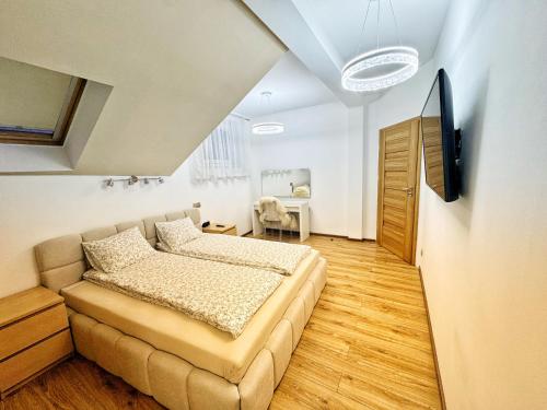 a bedroom with a bed and a television in it at Apartament Premium Skawina in Skawina