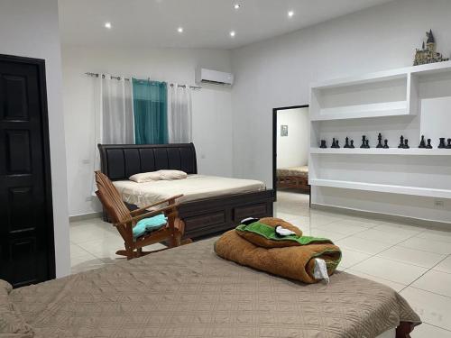 a bedroom with two beds and a mirror at apartamento hacia las olas Playa la Barqueta in Querévalo