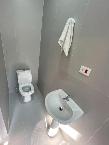 a bathroom with a sink and a toilet at WeStay Nova Cidade in São Paulo