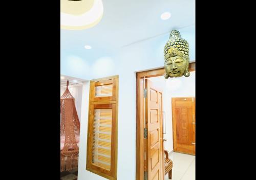 a room with a mask hanging from the ceiling at Pepper Jazz Varkala in Varkala