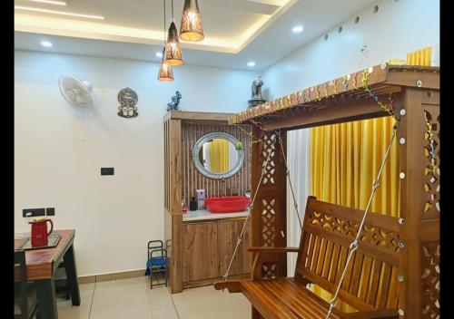a room with a sink and a mirror and a wooden structure at Pepper Jazz Varkala in Varkala