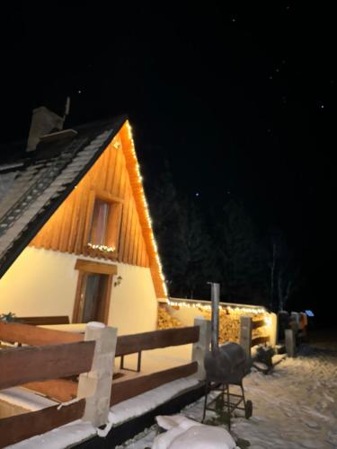 a house with lights on it in the snow at U Cejhonů in Měděnec