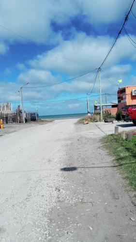 an empty road with the ocean in the background at Departamentos Lovaiza`s in Barrio Félix U Camet