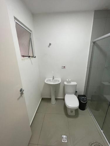 a bathroom with a toilet and a sink at WeStay Nova Cidade in São Paulo