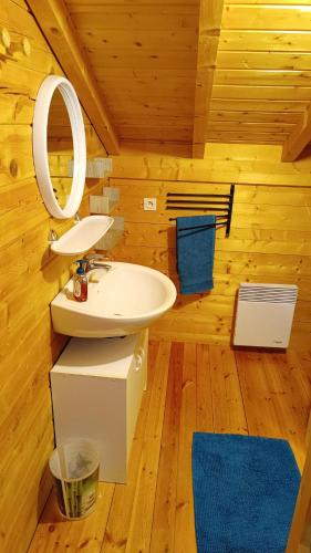 a bathroom with a sink and a mirror in a cabin at Chalet Les Hautes Cimes in Châtel