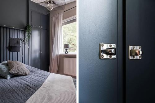 a bedroom with blue walls and a bed and a window at Green Villa in Tjörnarp