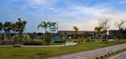 a building with a sign in the middle of a park at Bridge Residency-2 Top City-1 Islamabad in Islamabad