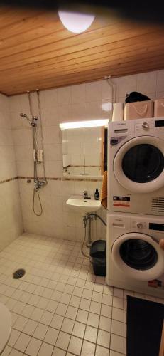 a bathroom with a shower and a sink and a microwave at Great apartment in Vantaa Close to the airport, with Sauna! in Vantaa