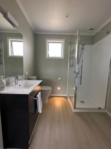 a bathroom with a sink and a shower at Evendale House in Hastings