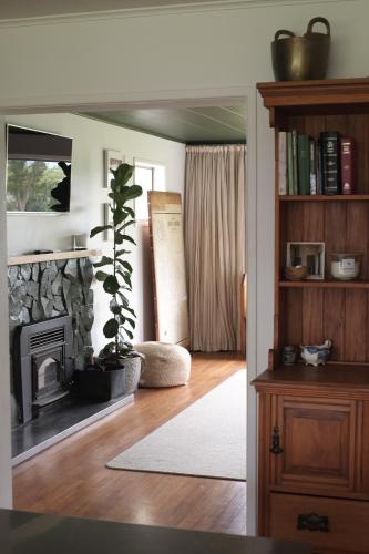 a living room with a fireplace and a plant at Evendale House in Hastings