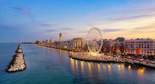 a city with a ferris wheel in the water at Loft Deluxe Clary in Bari