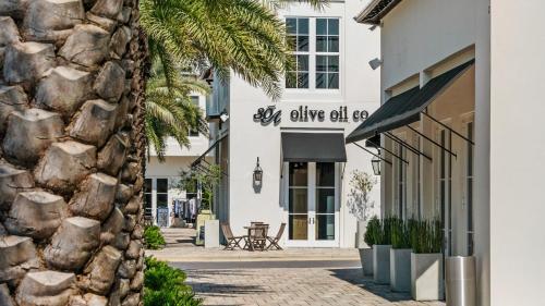 a facade of a white building with a stone wall at Mistral 10 in Seacrest