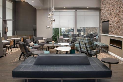a restaurant with tables and chairs and a fireplace at Residence Inn by Marriott Modesto North in Modesto