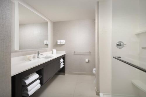 a white bathroom with a sink and a shower at Residence Inn by Marriott Modesto North in Modesto