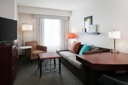 a living room with a couch and a table at Residence Inn by Marriott Lincoln South in Lincoln