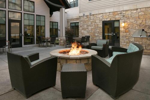 an outdoor patio with a fire pit and chairs at Residence Inn by Marriott Lincoln South in Lincoln
