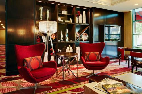 a living room with red chairs and a table at Las Vegas Marriott in Las Vegas
