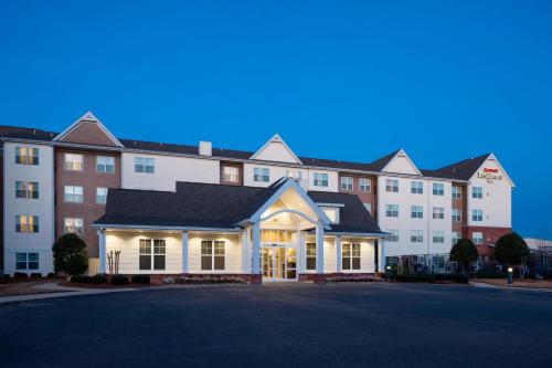 a large building with a parking lot in front of it at Residence Inn Jackson Ridgeland in Ridgeland