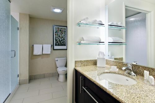 a bathroom with a sink and a toilet at Residence Inn by Marriott Little Rock Downtown in Little Rock