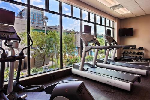 a gym with several tread machines and a large window at Residence Inn by Marriott Little Rock Downtown in Little Rock