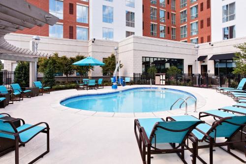 a large swimming pool with chairs and a table at Residence Inn by Marriott Little Rock Downtown in Little Rock