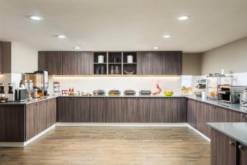 a kitchen with wooden cabinets and a counter top at Residence Inn San Diego La Jolla in San Diego