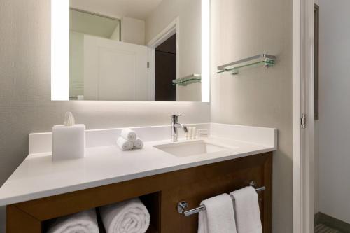 a bathroom with a sink and a mirror at Residence Inn by Marriott Missoula Downtown in Missoula