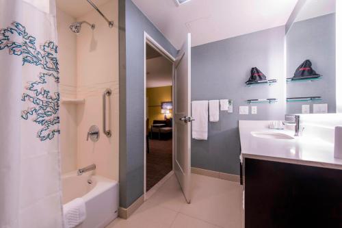 a bathroom with a tub and a sink and a shower at Residence Inn by Marriott Nashua in Nashua