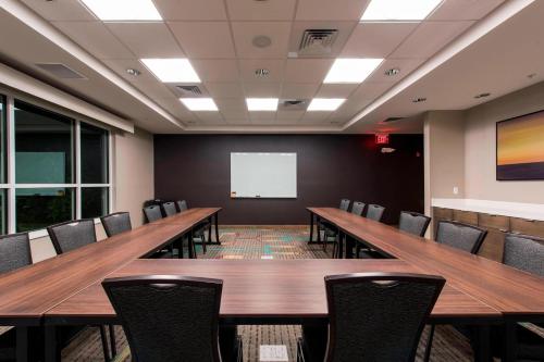 a conference room with tables and chairs and a whiteboard at Residence Inn by Marriott Nashua in Nashua