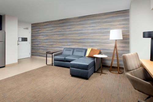 a living room with a blue couch and a table at Residence Inn by Marriott Lubbock Southwest in Lubbock