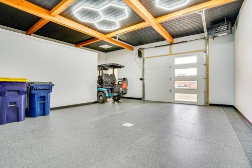 a garage with a garage door and a tractor in it at 1 Block to Lake City Marina Condo with Rooftop Deck in Lake City