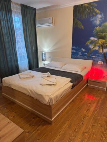 a bedroom with two beds and a painting on the wall at Pensiunea Sun Victor in Baile Felix