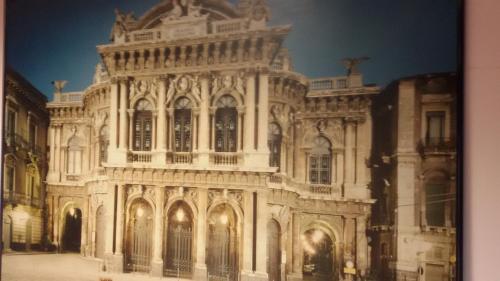an old stone building with a large building at B&B United States of Europe in Catania