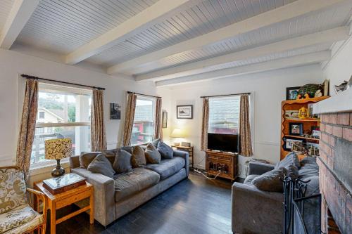 a living room with a couch and a tv at Big Blue in Neskowin