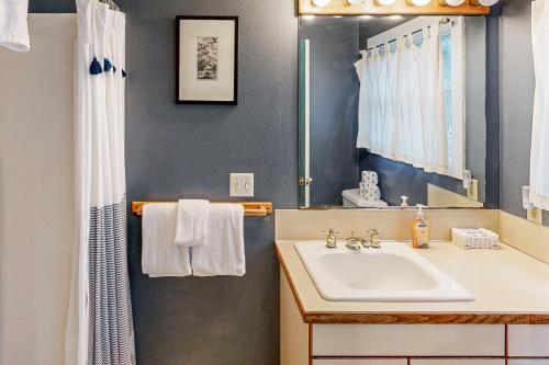 a bathroom with a sink and a mirror at Big Blue in Neskowin