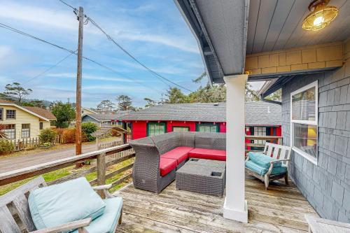 a patio with a couch and chairs on a deck at Big Blue in Neskowin
