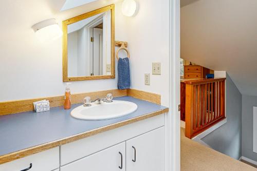 a bathroom with a sink and a mirror at Big Blue in Neskowin