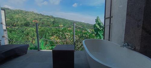 a bathroom with a tub and a view of a mountain at Abinawa Hill in Lovina