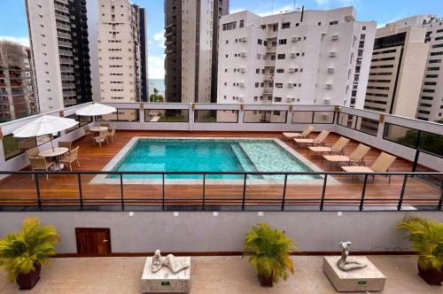 a swimming pool on the balcony of a building at Kastel Manibu Recife - Boa Viagem in Recife