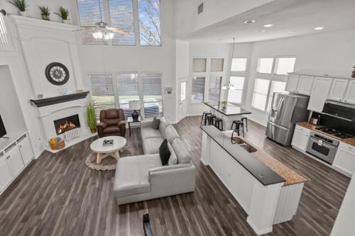 a large living room with a couch and a fireplace at Keller's Gem House & Spa in Keller