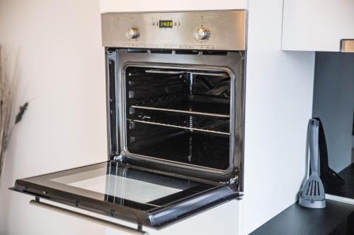 an oven with its door open in a kitchen at Comfort Apartment Oldenburg in Oldenburg
