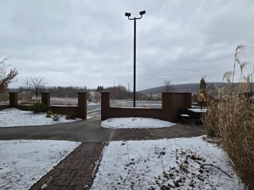a patio with a table and a light in the snow at Country Inn & Suites by Radisson, Convention Center in Altoona