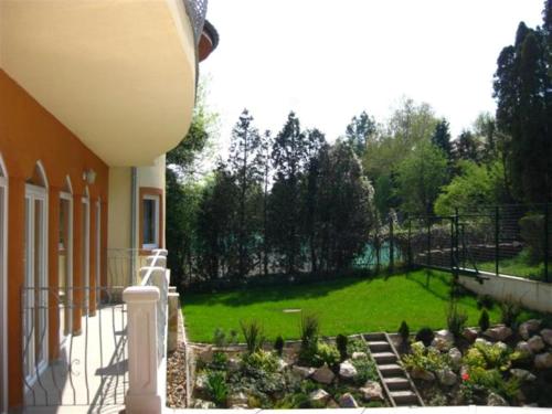 a porch of a house with a garden at SANTE Hévíz in Hévíz