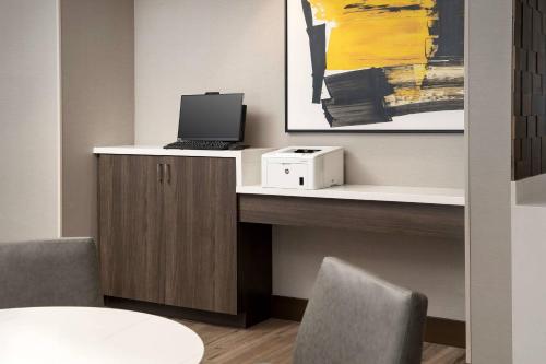 a desk with a laptop computer on top of it at Residence Inn Doral Mall Area in Doral