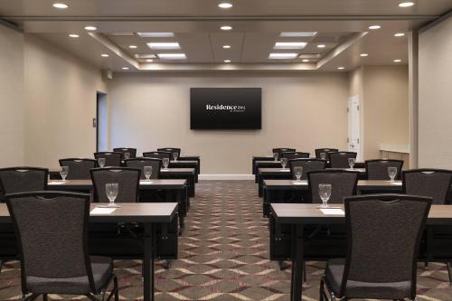 a conference room with tables and chairs and a screen at Residence Inn Walnut Creek in Walnut Creek
