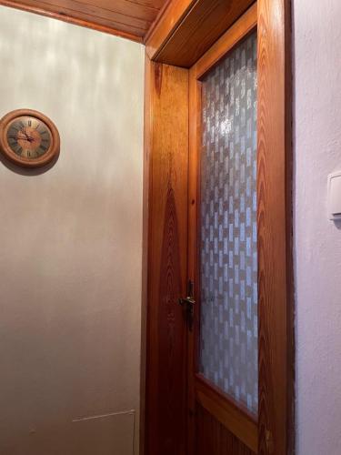 a door with a clock next to a window at Privat Medo in Děpoltovice