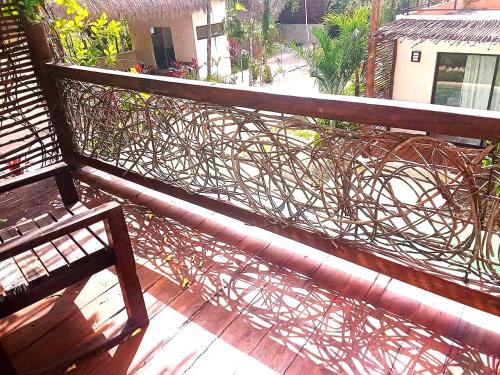 a wooden railing with vines on a balcony at Villa AHAL, in Chemuyil