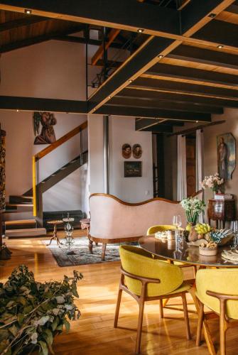 a living room with a table and a couch at Casa Santa Clara - Colonial Boutique Hotel in Quito